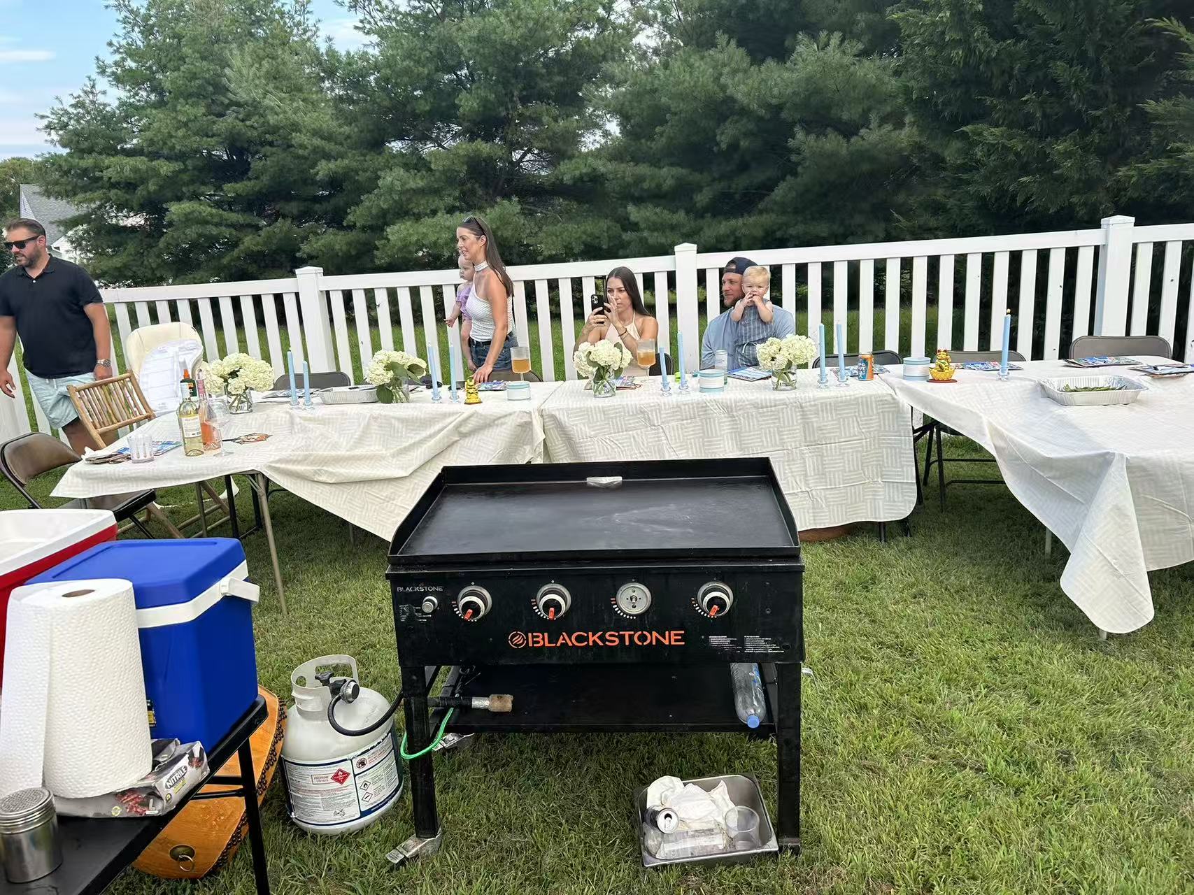 Family backyard hibachi party with kids and adults